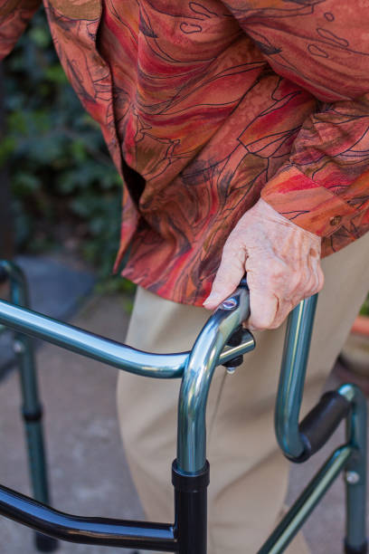 istock Elderly woman walking with collapsible walker 974884884