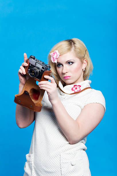 istock Blond girl look at retro camera 97488533