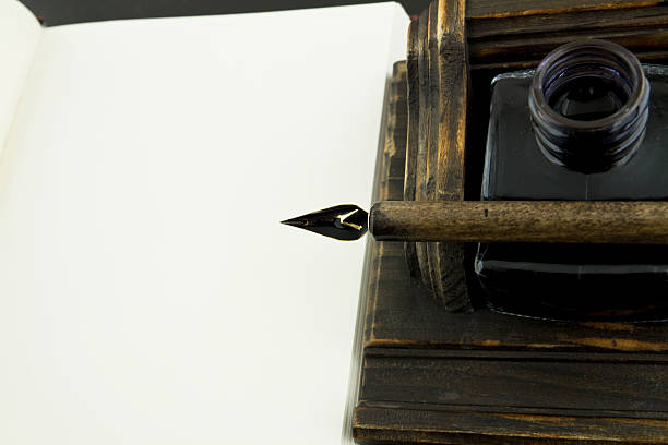 istock Fountain pen on ink pot and white book 97488733