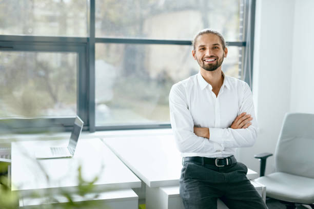 istock Man In Office. Smiling Business Man Portrait 974887522