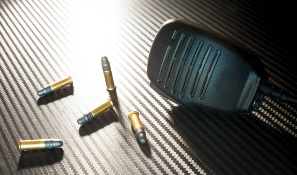 istock Rimfire ammunition and two way radio mike 974888454
