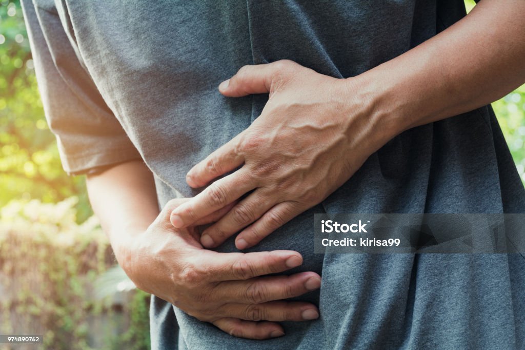 Male suffering from stomachache pain,A man stomachache at outdoor,Healthy concept. Intestine Stock Photo