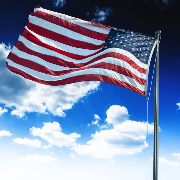 istock us flag waving on the sky 974904186