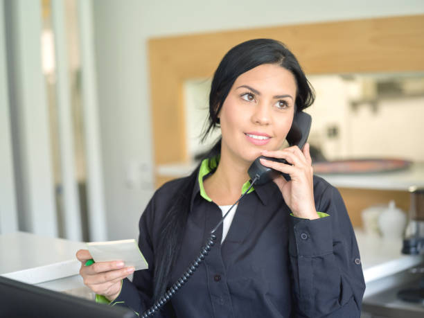 istock Waitress talking on the phone at a restaurant 974905578