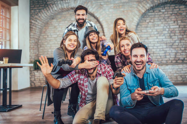 istock Coworkers playing video games in office 974916116