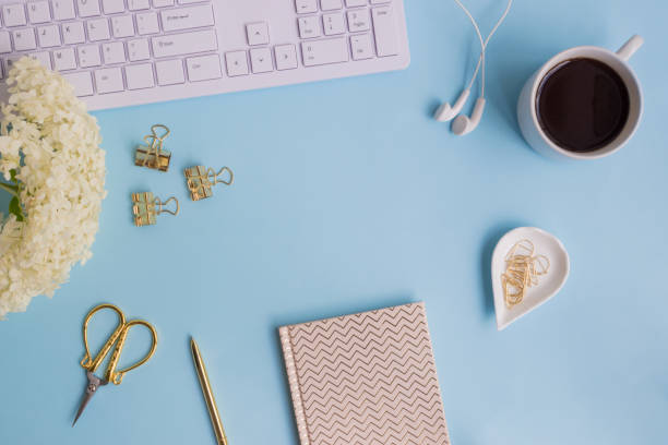 istock Blogger or freelancer workspace with notebook and white flower hydrangea 974918770