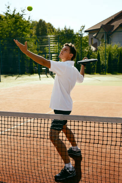istock Man Playing Tennis Outdoors. 974922132