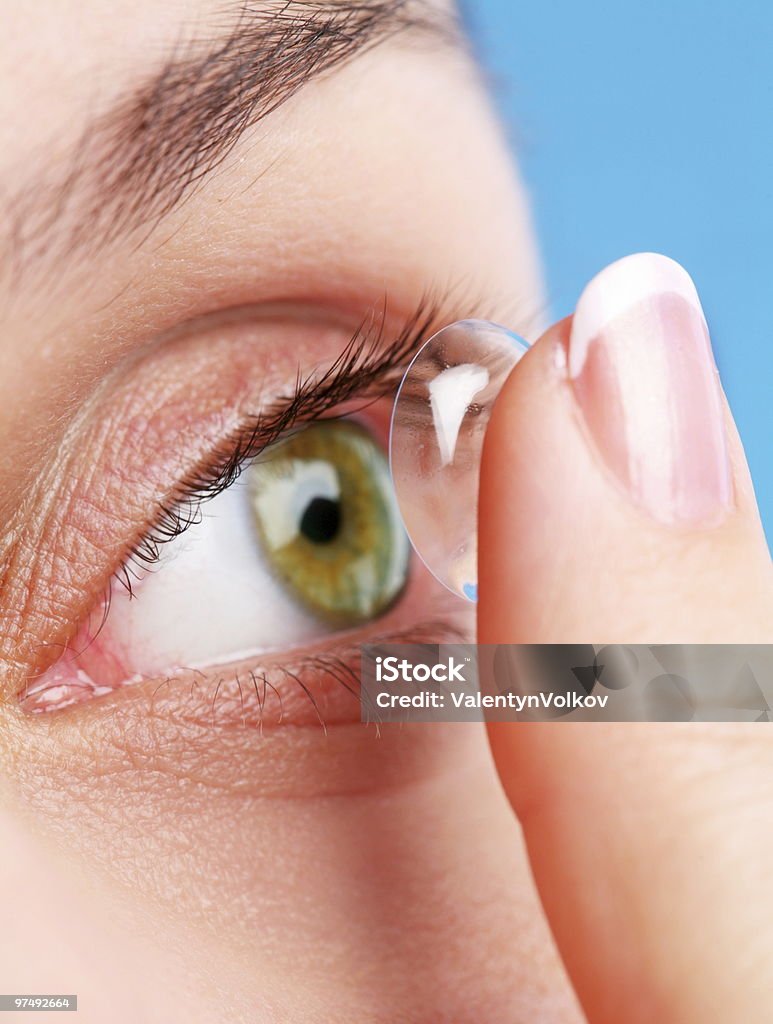 human eye with corrective lens on a blue  Adult Stock Photo