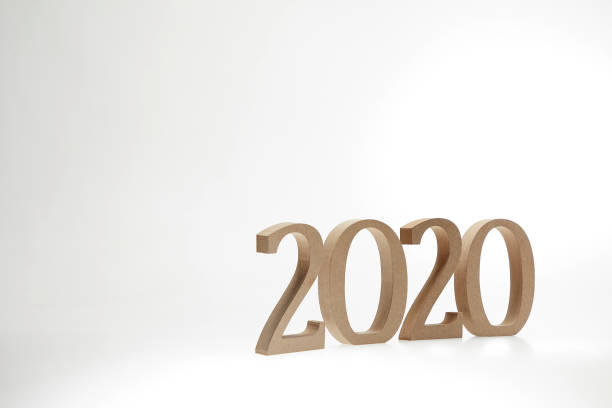 istock Year 2020 in wooden numbers on white background 974929858
