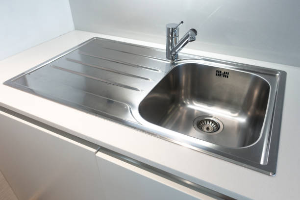 istock Metallic kitchen sink with wooden plates 974931540