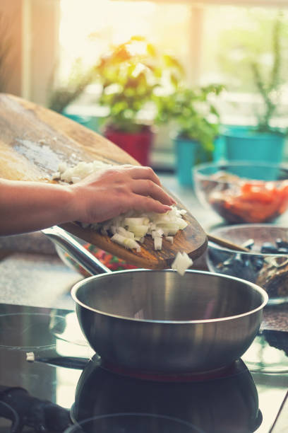 istock Young Woman Preparing Paella 974938188
