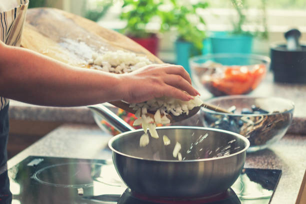 istock Young Woman Preparing Paella 974938302