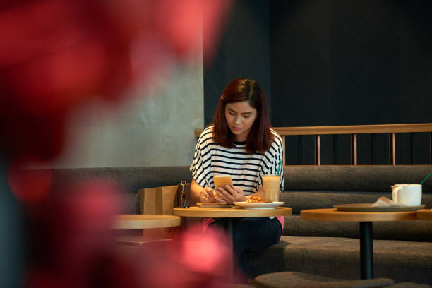istock Asian Woman Working at Cafe 974938496