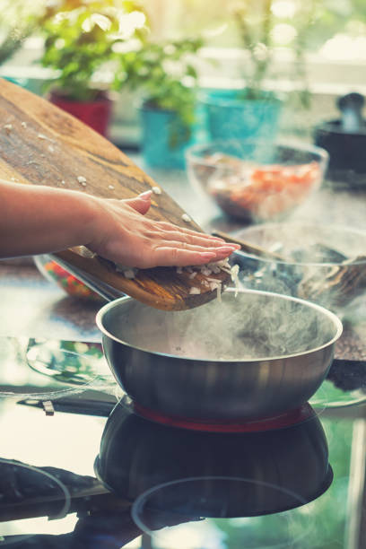 istock Young Woman Preparing Paella 974938882