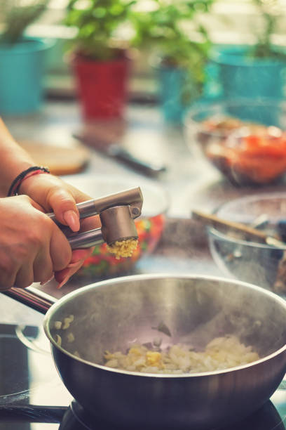 istock Young Woman Preparing Paella 974938884