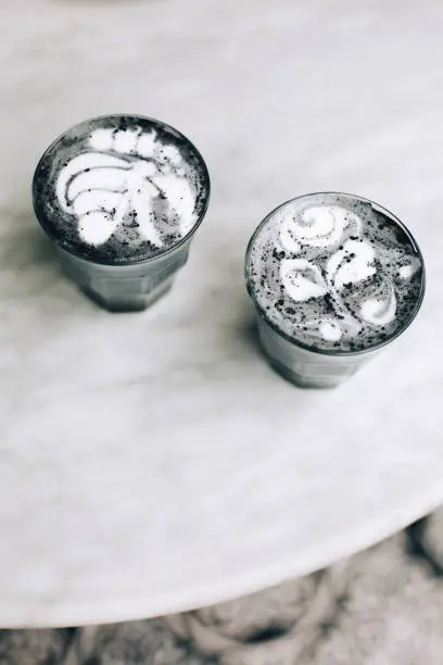 Photo of Two activated charcoal lattes