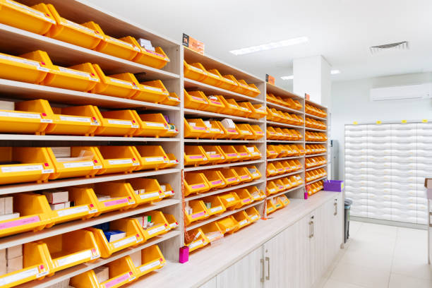 Medicine storage containers on pharmacy shelves Rows of plastic boxes containing drugs and medical supplies in a hospital pharmacy filing tray stock pictures, royalty-free photos & images