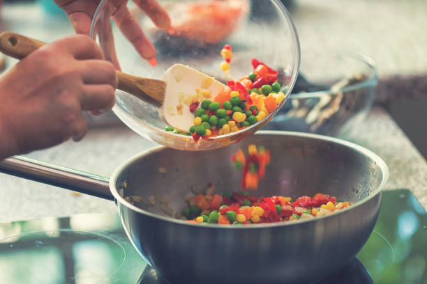 istock Young Woman Preparing Paella 974943082