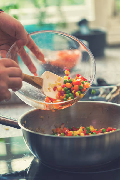 istock Young Woman Preparing Paella 974943390