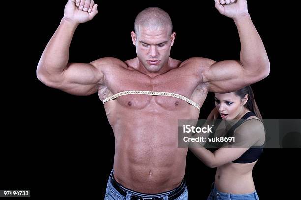 Beautiful Young Woman Measuring Males Pecs Stock Photo - Download