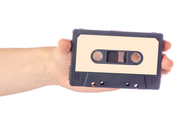 istock Audio cassette in hand stereo music 974952100
