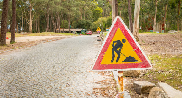 istock temporary road sign indicating work on a small road in the forest 974959318