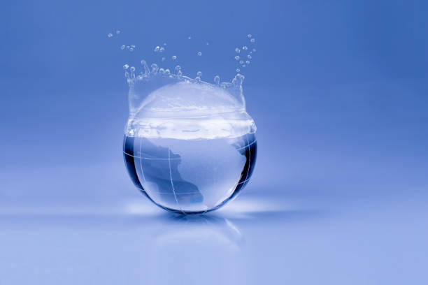 istock Water drops on the glass globe on blue background 974966750