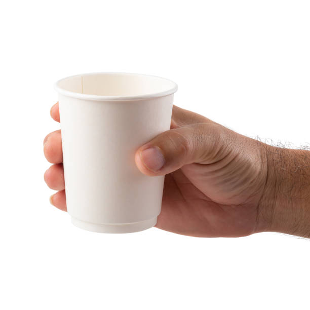 istock Hands of a man holding a coffee mug on a white background 974967046