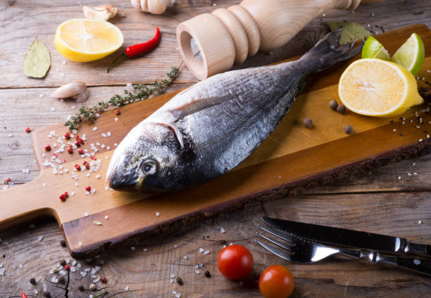istock Raw fish with herbs and spices 974967258