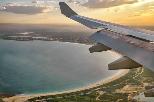 istock Airplane wing seen from airplane window approaching Sydney, Australia. 974967856