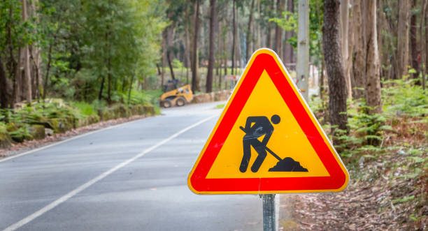 istock temporary road sign indicating work on a small road in the forest 974969072