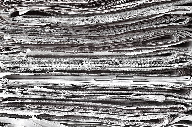 Pile of folded newspapers stock photo