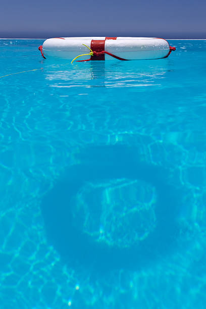 istock A red and white lifesaver floating in a swimming pool 97497372