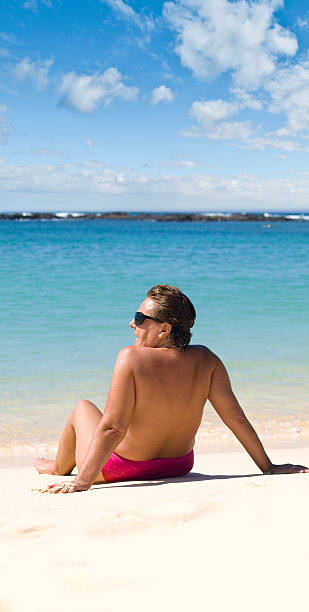 istock Mature woman relaxing in the beach 97499794