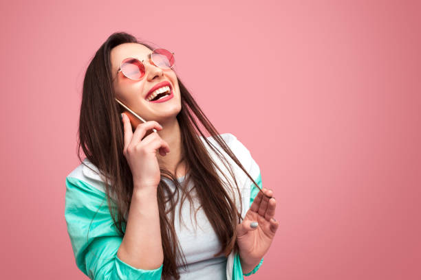 istock Laughing woman speaking on phone 975002482