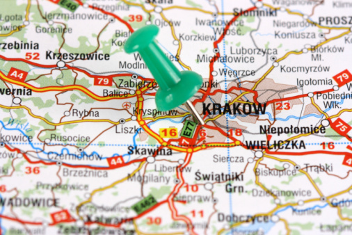 Krakow, Poland, Europe. Push pin on an old map showing travel destination. Selective focus.