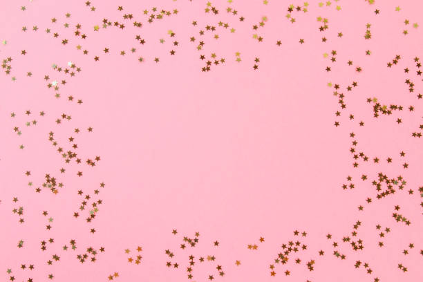 istock Empty space on a pastel background surrounded by shiny decorative stars and balls. 975025878