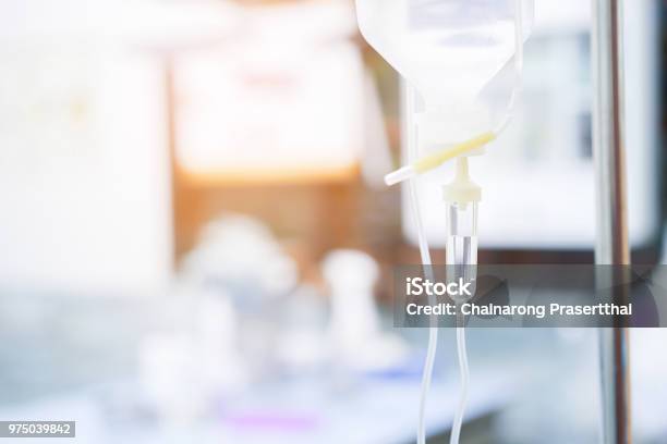 Close Up Blur Medical Iv Drip With Tubing Hanging On Standing In Operation Surgery Room Waiting For Transfer Saline Solution To Patient Medical Therapy Concept Stock Photo - Download Image Now