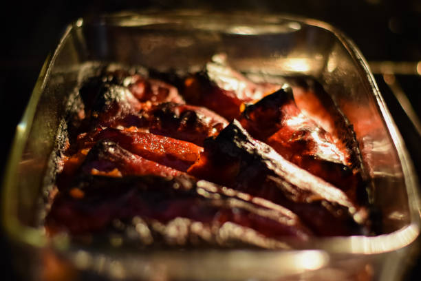 sausages hung and arranged decoratively with some ingredients such as various chili peppers before being placed on the grill