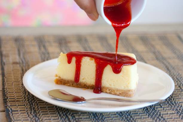 istock Cropped Hand Pouring Preserves On Cake At Table 975060642