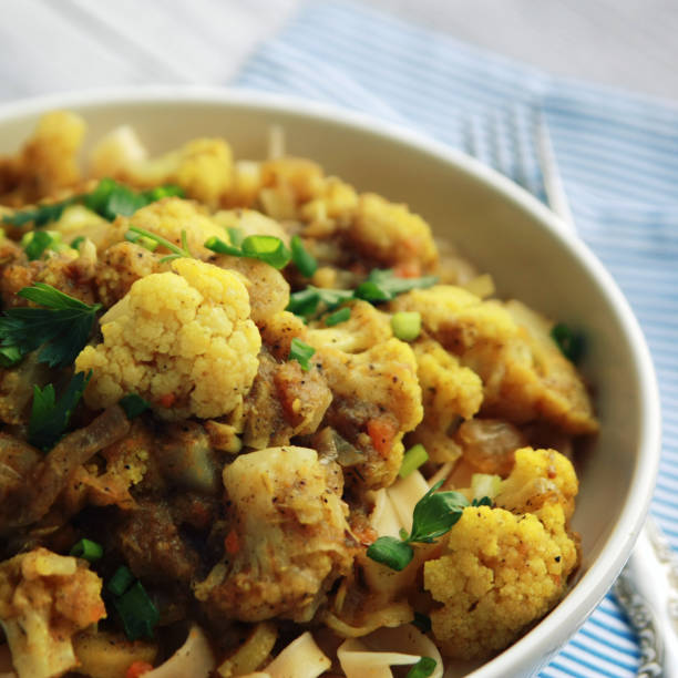 istock Cauliflower stew with curry. Vegetarian cuisine. 975060684