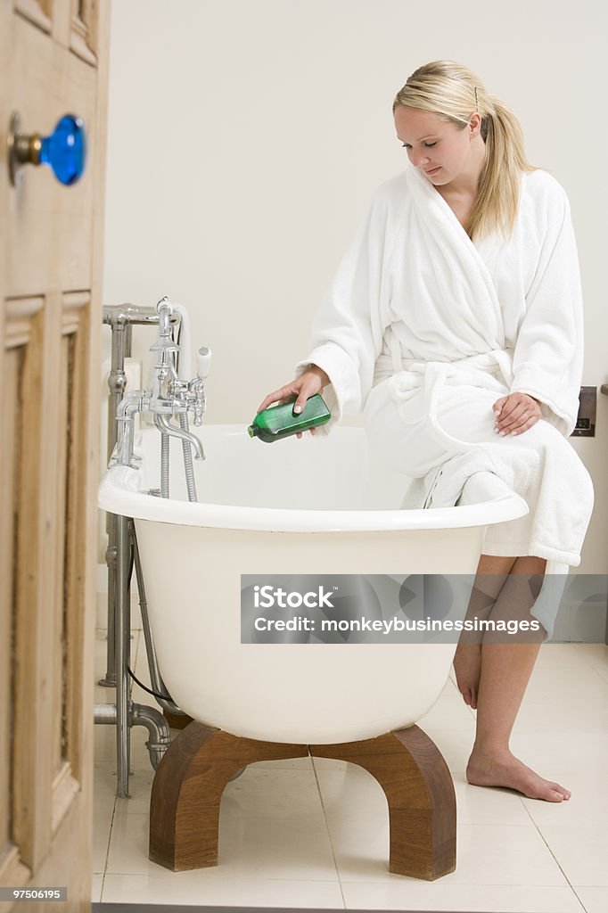 Woman putting bubble bath in bathtub  20-29 Years Stock Photo