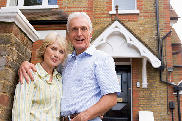 istock Husband and Wife Hugging Outside House 97506312
