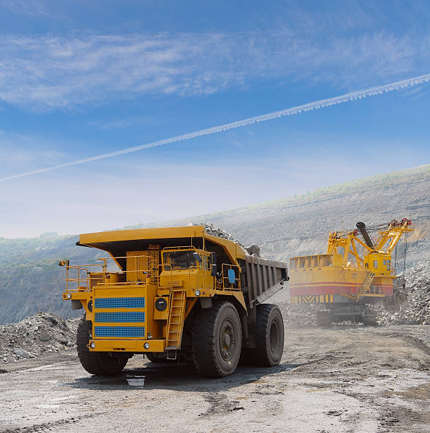 istock Loading of iron ore into big yellow dump truck 97506519