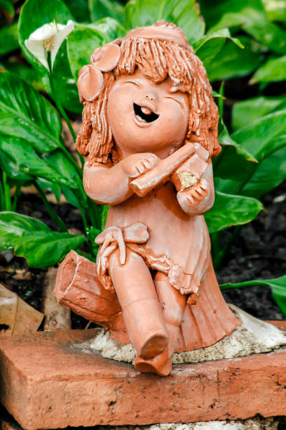 istock Clay dolls used for garden decoration. 975074140
