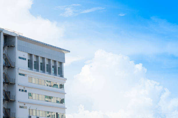 istock New building architecture with fire escape stairs on blue sky background 975074174