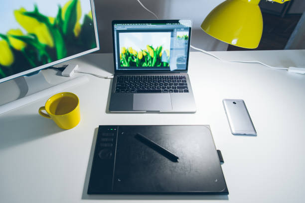 istock workplace. white desk with laptop and yellow cup. designer working place 975081490