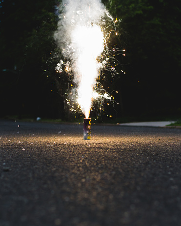 Small novelty cake fireworks exploding on a quiet street