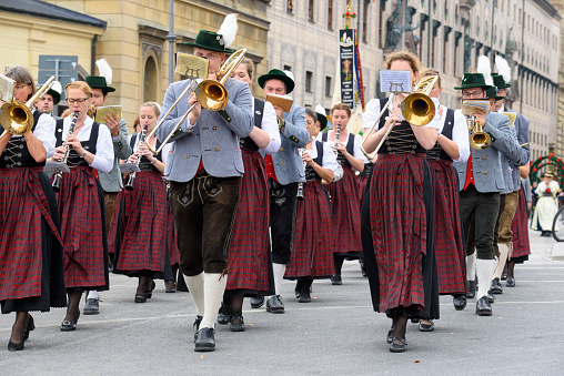 opening parade of the world-famous Oktoberfest in Munich with music band in historical and traditional costumes