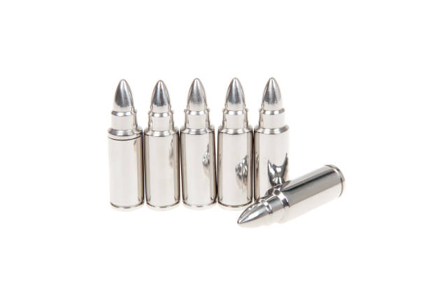 Close up of silver bullets in a row, isolated on white Close up of silver bullets in a row, isolated on white Silver Bullet stock pictures, royalty-free photos & images